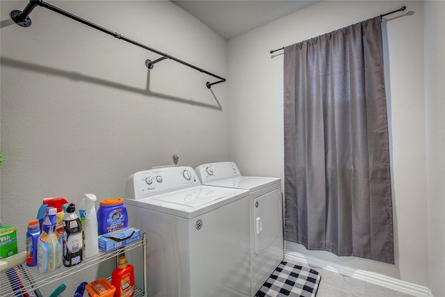 laundry area with washing machine and dryer and light tile patterned flooring