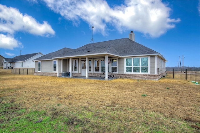 back of house with a lawn