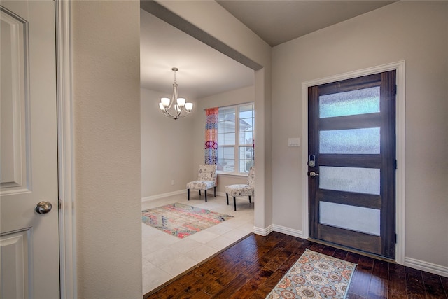 entryway featuring dark hardwood / wood-style floors and a chandelier