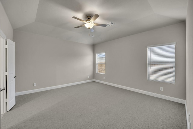 carpeted empty room with vaulted ceiling and ceiling fan