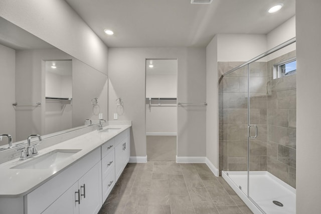 bathroom featuring walk in shower and vanity