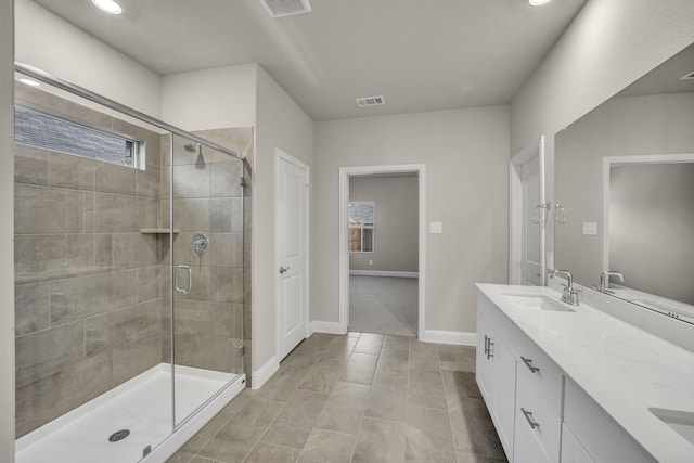 bathroom with vanity and a shower with shower door