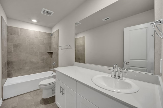 full bathroom with tiled shower / bath, vanity, toilet, and tile patterned floors