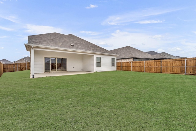 rear view of property featuring a patio and a yard