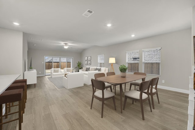 dining area with light hardwood / wood-style floors and ceiling fan