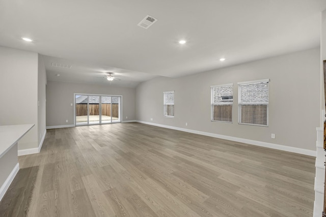 unfurnished living room featuring ceiling fan and light wood-type flooring