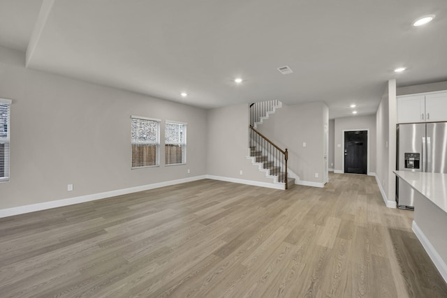 unfurnished living room with light wood-type flooring