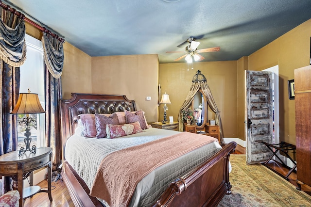 bedroom with ceiling fan and light wood-type flooring