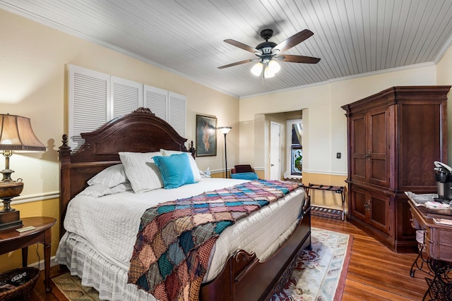 bedroom with wood ceiling, ceiling fan, ornamental molding, and dark hardwood / wood-style flooring