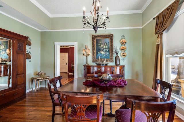 dining area with an inviting chandelier, ornamental molding, and dark hardwood / wood-style floors