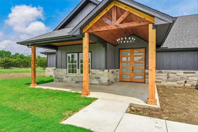 doorway to property featuring a lawn and french doors