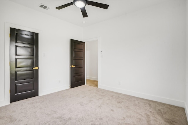 carpeted empty room with ceiling fan