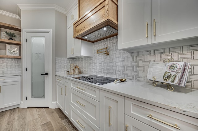 kitchen with white cabinets and custom range hood