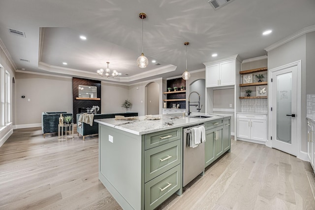 kitchen featuring open shelves, stainless steel dishwasher, arched walkways, green cabinets, and a raised ceiling