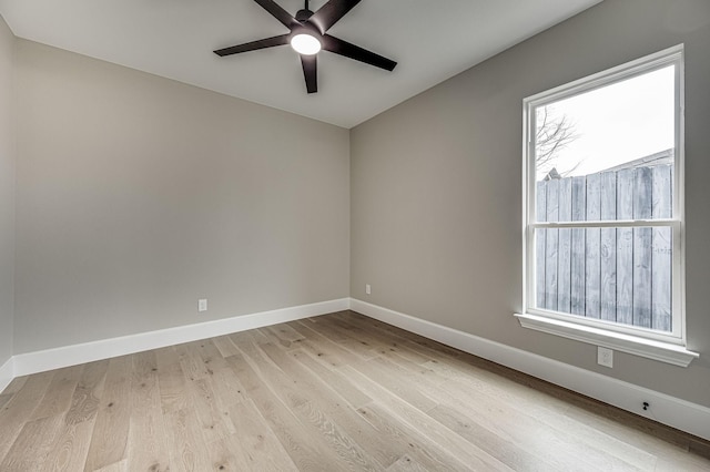 unfurnished room featuring light wood-type flooring, baseboards, and a ceiling fan