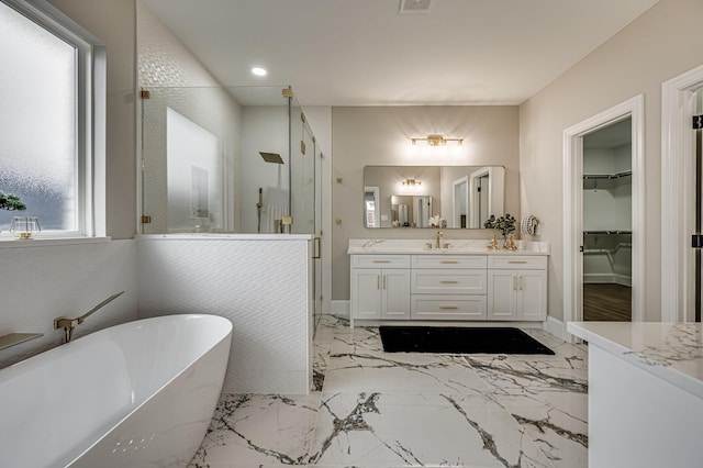 full bathroom with a stall shower, visible vents, a soaking tub, marble finish floor, and vanity