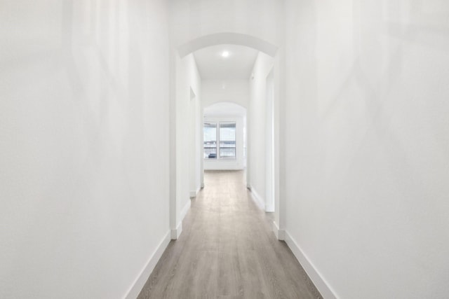 corridor with light hardwood / wood-style flooring