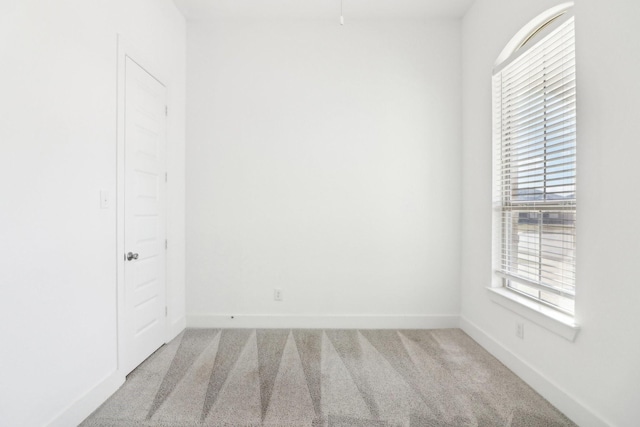 spare room with light colored carpet