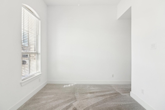 spare room with light carpet