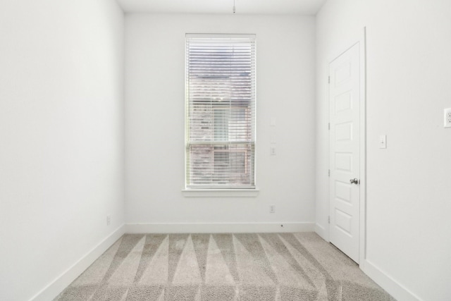 spare room featuring light carpet