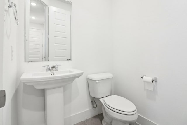 bathroom featuring tile patterned floors and toilet