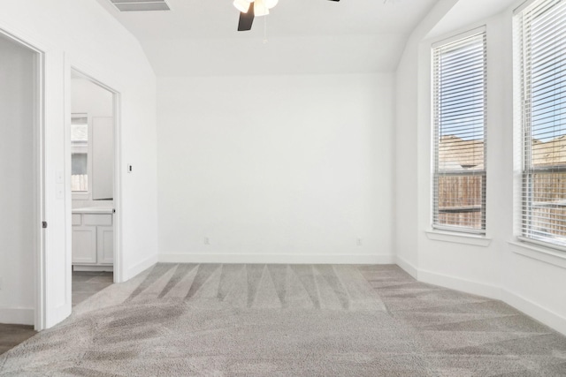 carpeted spare room with vaulted ceiling and ceiling fan