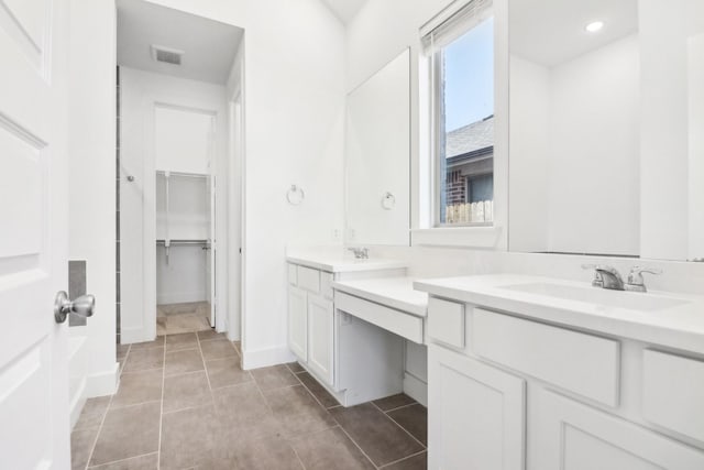 bathroom with tile patterned flooring and vanity