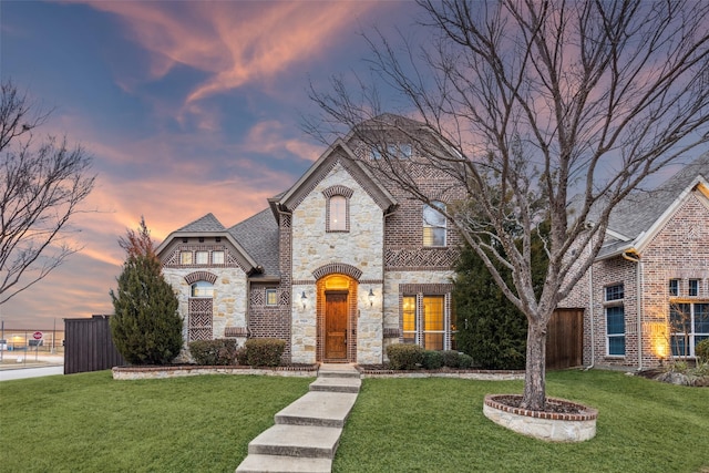 french country style house with a lawn