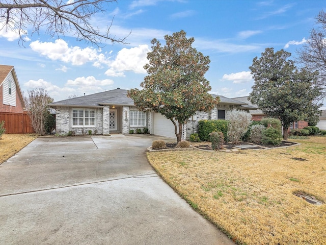 view of front of property featuring a garage and a front lawn