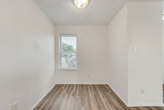 5109 Herrick Ct Unit A-D, Haltom City, TX 76117 - unfurnished room with wood finished floors, a textured ceiling, and baseboards