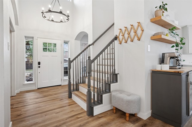 kitchen with white cabinetry, sink, a center island, light hardwood / wood-style floors, and stainless steel appliances