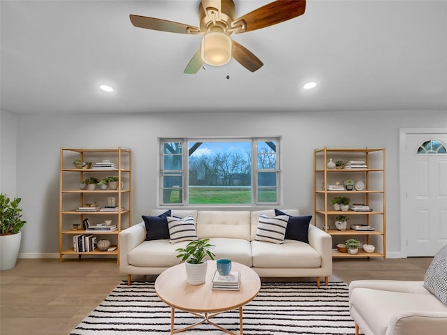 living room featuring ceiling fan and wood-type flooring