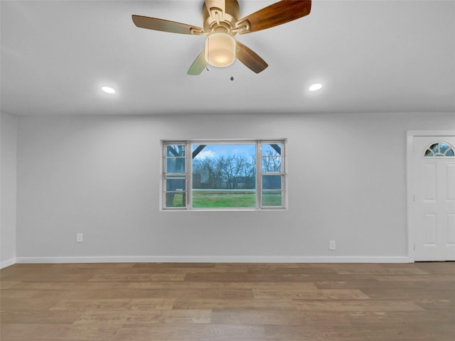 unfurnished room with ceiling fan and light hardwood / wood-style floors