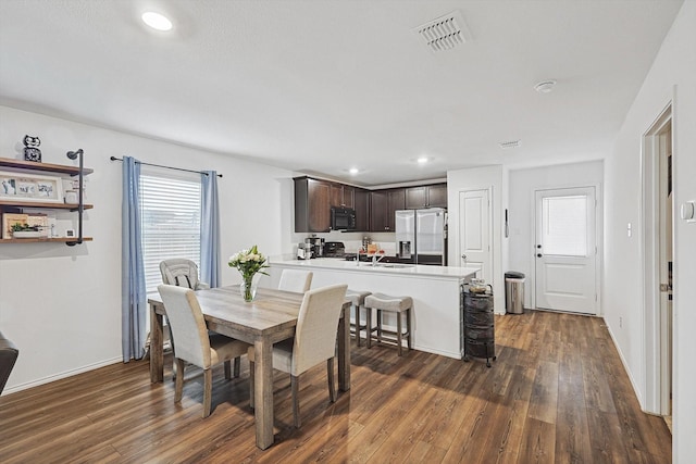 dining space with sink and dark hardwood / wood-style floors