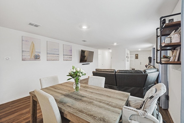 dining area with dark hardwood / wood-style floors