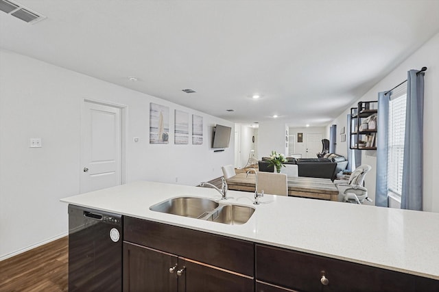 kitchen with dark hardwood / wood-style flooring, black dishwasher, sink, and dark brown cabinets