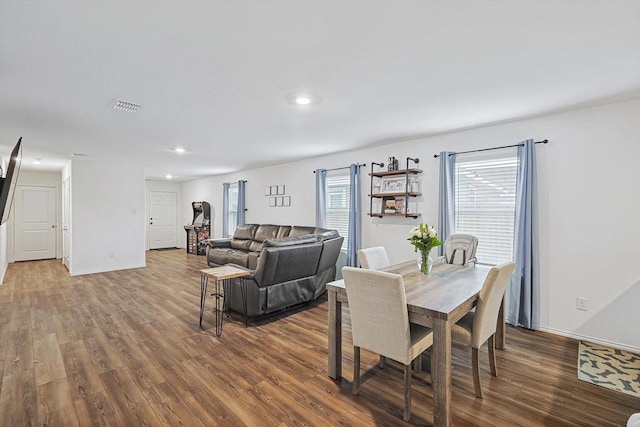 dining space with hardwood / wood-style floors