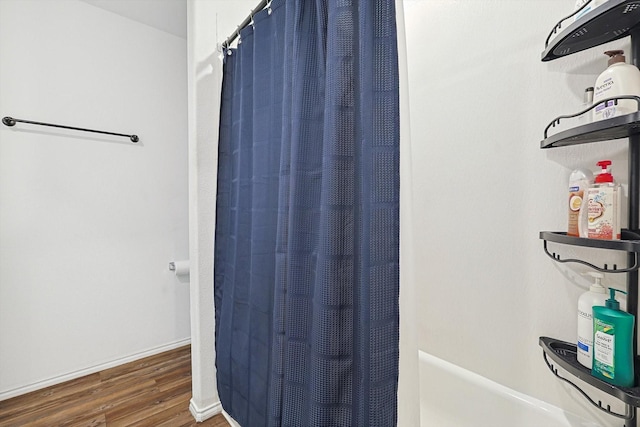 bathroom featuring hardwood / wood-style flooring and shower / bath combo