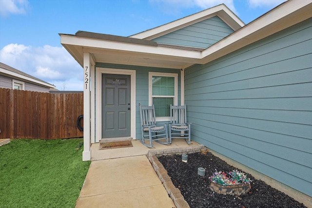 property entrance with a lawn