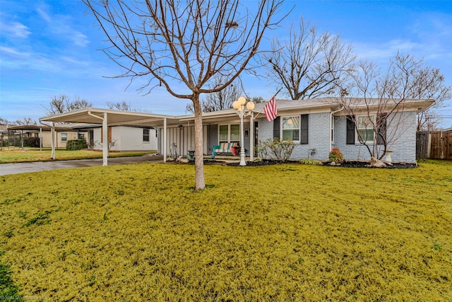 single story home featuring a front lawn and a carport