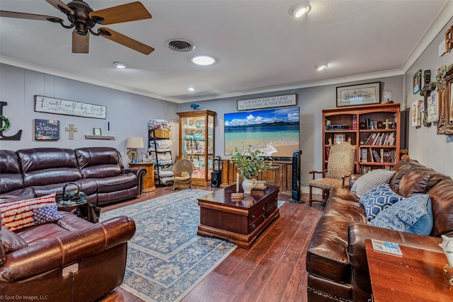 living room featuring dark hardwood / wood-style flooring, crown molding, and ceiling fan