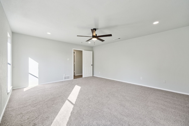 carpeted empty room featuring ceiling fan