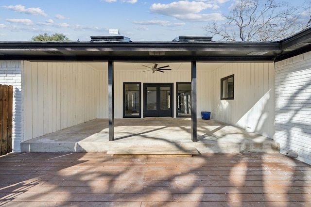 rear view of property with a wooden deck and ceiling fan