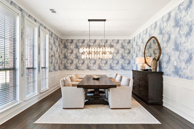 dining area featuring a notable chandelier, crown molding, and dark wood-type flooring