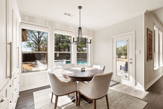 dining room featuring crown molding, a notable chandelier, and dark hardwood / wood-style flooring