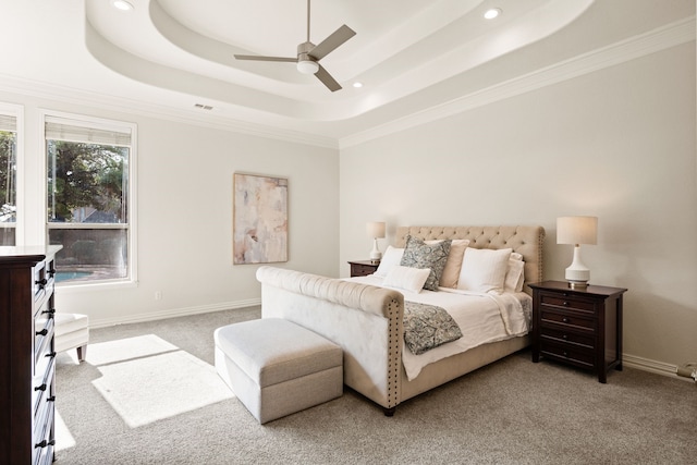 carpeted bedroom featuring a raised ceiling, crown molding, and ceiling fan