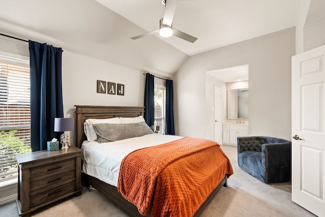 carpeted bedroom featuring lofted ceiling, connected bathroom, and ceiling fan