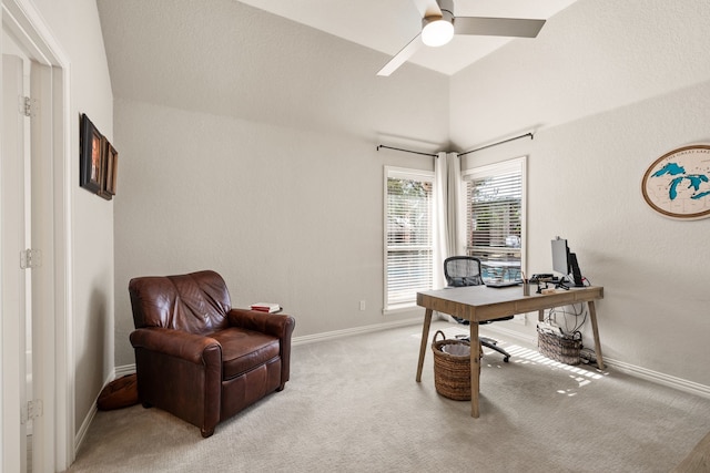 carpeted office space with ceiling fan and lofted ceiling