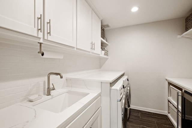 clothes washing area featuring sink and independent washer and dryer