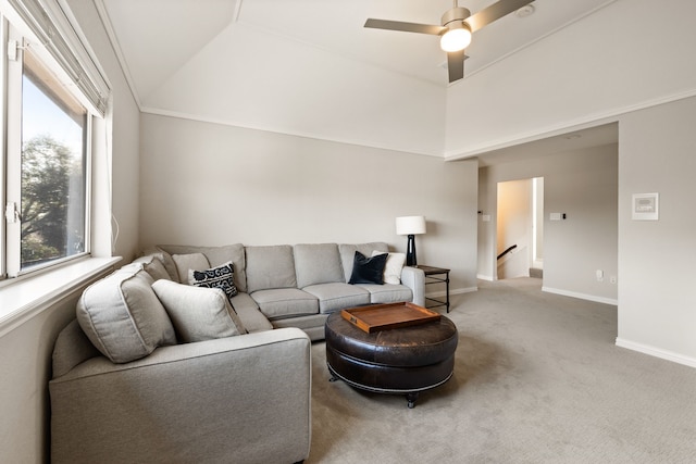 carpeted living room featuring ceiling fan and lofted ceiling